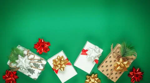 Christmas composition made of different presents on Green background. Stock Photos