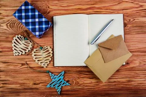 Christmas composition. Notebook to write goals for the new year on wooden bro Stock Photos