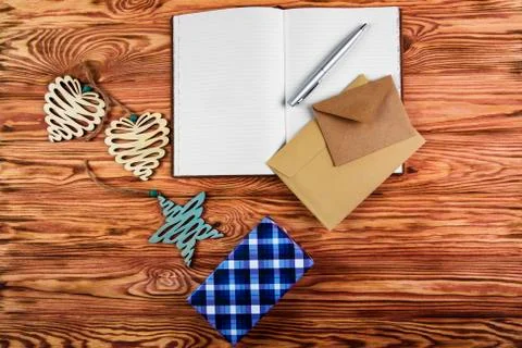 Christmas composition. Notebook to write goals for the new year on wooden bro Stock Photos