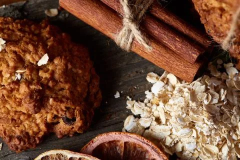 Christmas composition with oatmeal, chocolate biscuits, and spices, on wooden Stock Photos