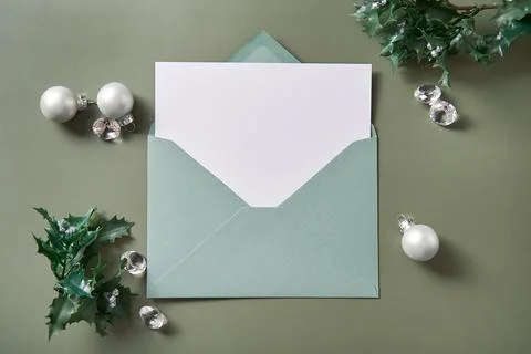Christmas composition with an open envelope and blank white paper. Xmas mockup Stock Photos