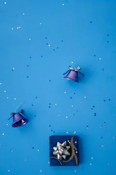 Christmas composition. A pattern of christmas blue bells, gift box. Stock Photos
