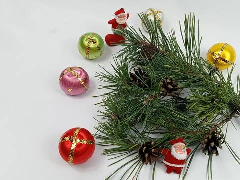 Christmas composition with pine branch, cones, Santa Claus toy and colorful Stock Photos