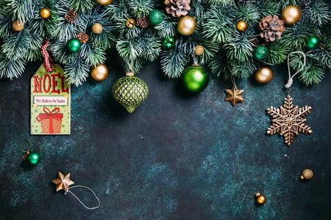 Christmas composition. Pine branches, green and gold  decorations on green ba Stock Photos