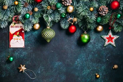 Christmas composition. Pine branches, green, red and gold  decorations on gre Stock Photos