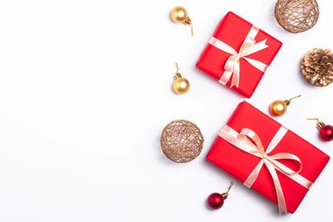 Christmas composition. Red gift box, pine cones, gold and red ornaments Stock Photos