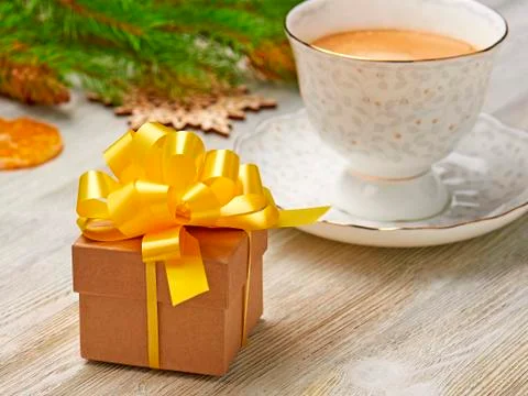 Christmas composition. Small gift box with lush yellow bow on a background of Stock Photos