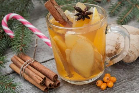 Christmas composition. Spruce branches, candy cane, warming tea Stock Photos