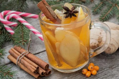Christmas composition. Spruce branches, candy cane, warming tea Stock Photos