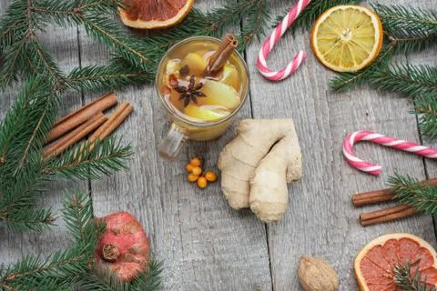Christmas composition. Spruce branches, candy cane, warming tea Stock Photos