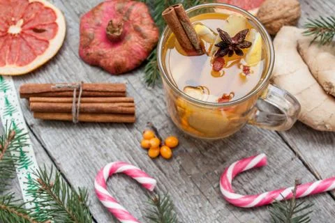 Christmas composition. Spruce branches, candy cane, warming tea Stock-Fotos