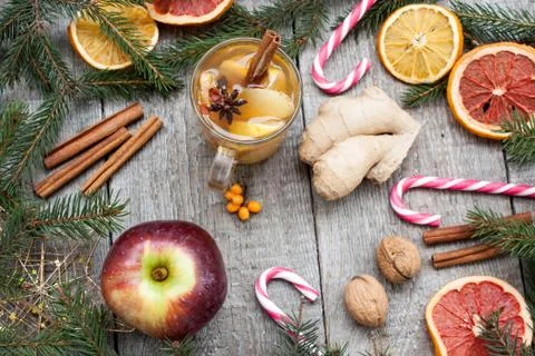 Christmas composition. Spruce branches, candy cane, warming tea Stock Photos
