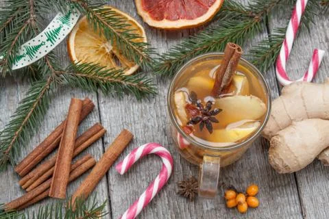 Christmas composition. Spruce branches, candy cane, warming tea Stock Photos
