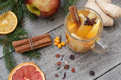 Christmas composition. Spruce branches, candy cane, warming tea Stock Photos