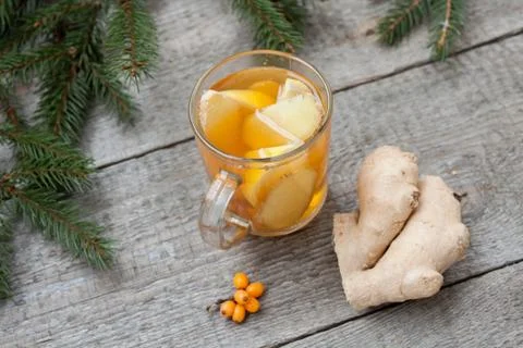 Christmas composition. Spruce branches, candy cane, warming tea Stock Photos