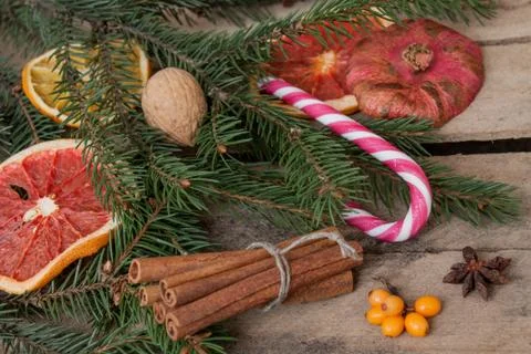 Christmas composition. Spruce branches, candy cane, warming tea with ginger Stock Photos