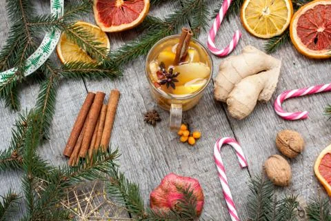Christmas composition. Spruce branches, candy cane, warming tea Stock Photos