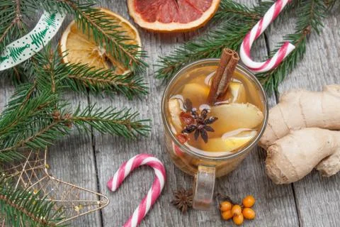 Christmas composition. Spruce branches, candy cane, warming tea Stock Photos
