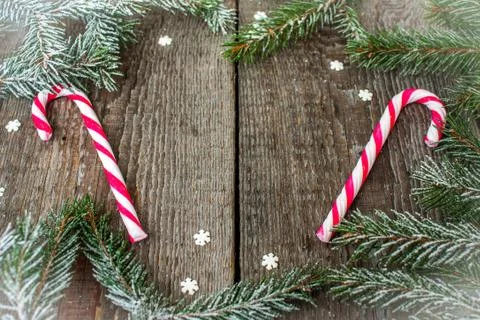 Christmas composition. Spruce branches, candy cane, snowflake Stock Photos