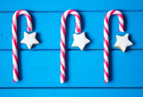 Christmas composition with star-shaped gingerbread cookies and candies on blue Stock Photos