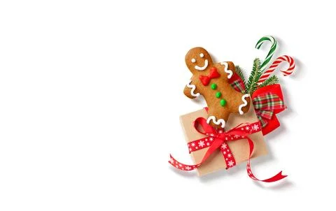 Christmas composition Top view of gingerbread man with a wrapped gift, red .. Stock Photos