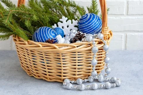 Christmas composition - wicker basket with decorations and fir branches on a  Stock Photos