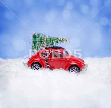 Christmas concept with car toy carrying a Christmas tree Stock Photos