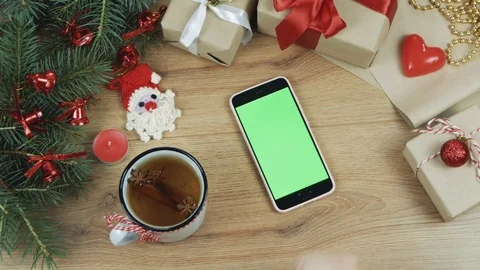 Christmas concept. Top view. Black phone with pink case with green screen on  Stock-Footage 110704419