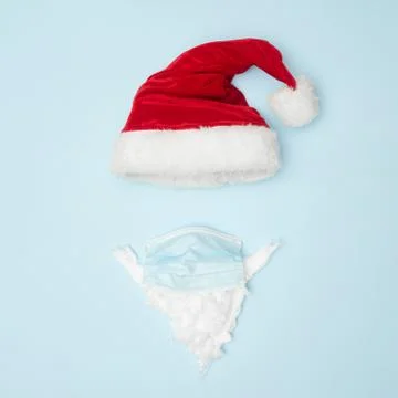 Christmas concert, christmas hat medical mask on a blue background, top view Stock Photos