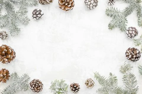 Christmas creative frame made of cones and fir branches on white background with Stock Photos