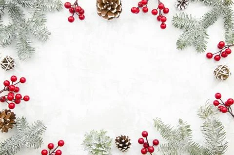 Christmas creative frame made of cones, red berry and fir branches on white Stock Photos
