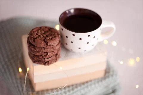 Christmas cup of coffee with cookies on stack of books closeup. Winter season Stock Photos