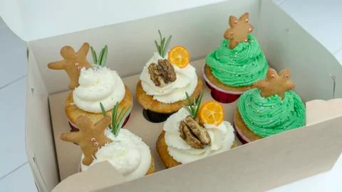Christmas cupcakes in a box on the table Stock Photos