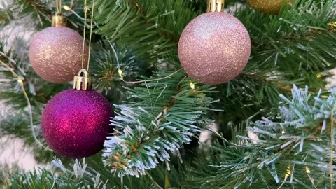 Christmas decor on an artificial fir tree in the snow close-up, Christmas lights Stock Footage 255039797