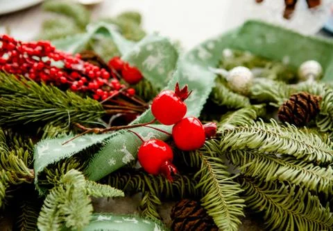 Christmas decor elements in the form of berries on a fir branch Stock Photos