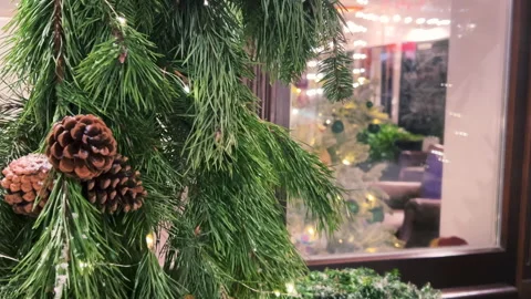 Christmas decor in the form of coniferous branches and electric garlands Stock Footage 295811085