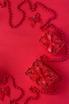 Christmas decor gift boxes bows beads red colors wooden background Stock Photos