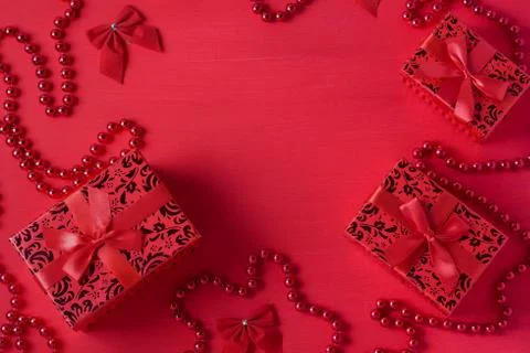 Christmas decor gift boxes bows beads red colors wooden background Stock Photos