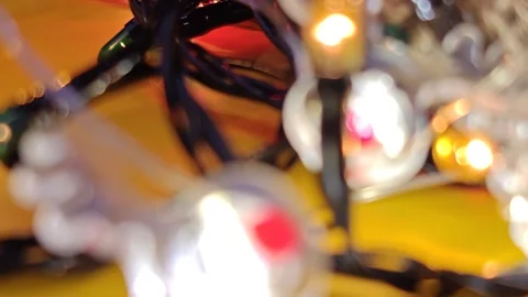Christmas decor made of shimmering lights on a bright yellow background, macro p Stock Footage 322675883