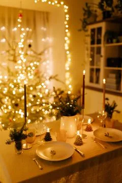 Christmas decor in the setting of a festive table for lunch or dinner. Stock Photos