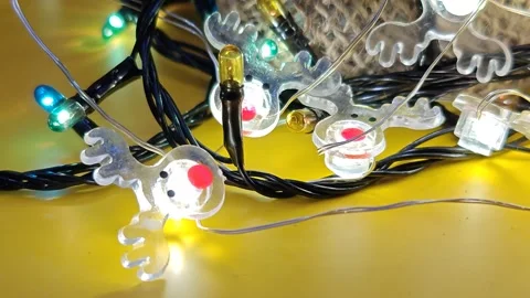 Christmas decor with shimmering lights on a bright yellow background Stock Footage 322675907