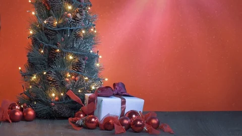 Christmas decorated background with a present, tree, and flashing lights Stock-Footage 119985757
