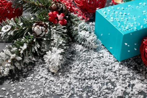 Christmas decoration and blue gift box on a table covered with snow. Christmas Stock Photos