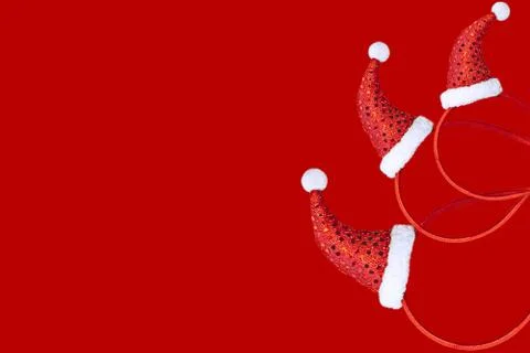 Christmas decoration in the form of a pattern with a red cap on a red backgro Stock Photos