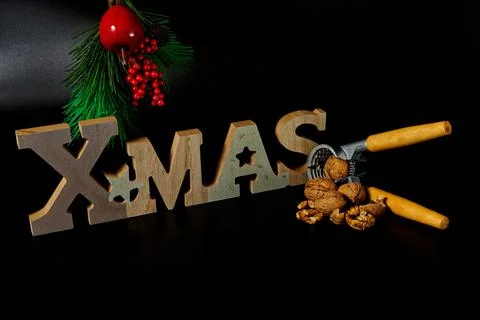 Christmas decoration with nutcracker and some walnuts and xmas wooden text Stock Photos