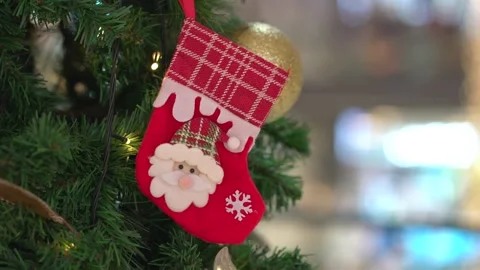 Christmas decoration of red craft stocking and ball hanging on tree. Stock Footage 322144566
