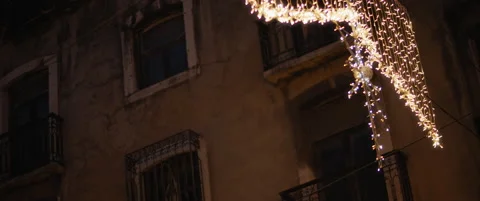 Christmas decorations against the medieval facade during a holiday season. Stock Footage 141364572