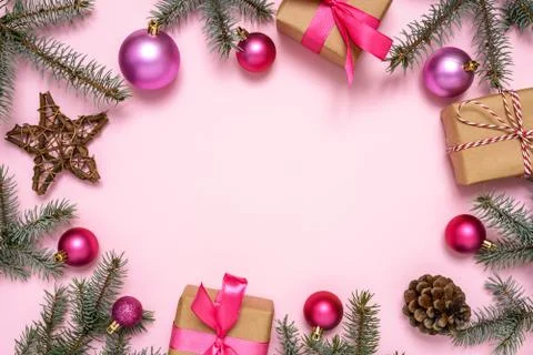 Christmas decorations and fir tree on pink background Stock Photos