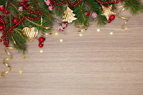 Christmas decorations and spruce branches on a wooden background Stock Photos