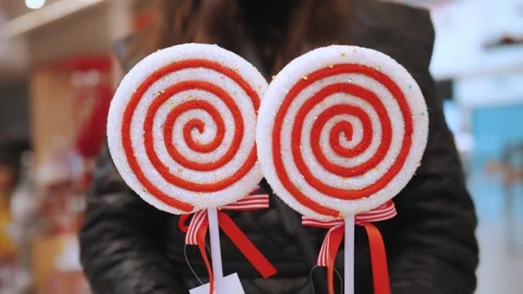 Christmas decorations. big lollipops. close-up. woman holds in hands two large Stock Footage 255877125